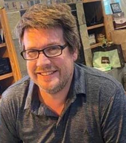 man with grey polo shirt 
